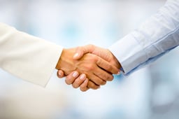 Successful business people handshaking closing a deal